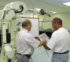 Brian Harvey and Ted Szenborn review instructions before operating the training robot.