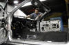  Working with care and precision, a Dearborn Assembly employee adds his work to the production of a 2004 Ford Mustang at the Plant